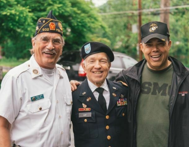 group of military veterans smiling at camera